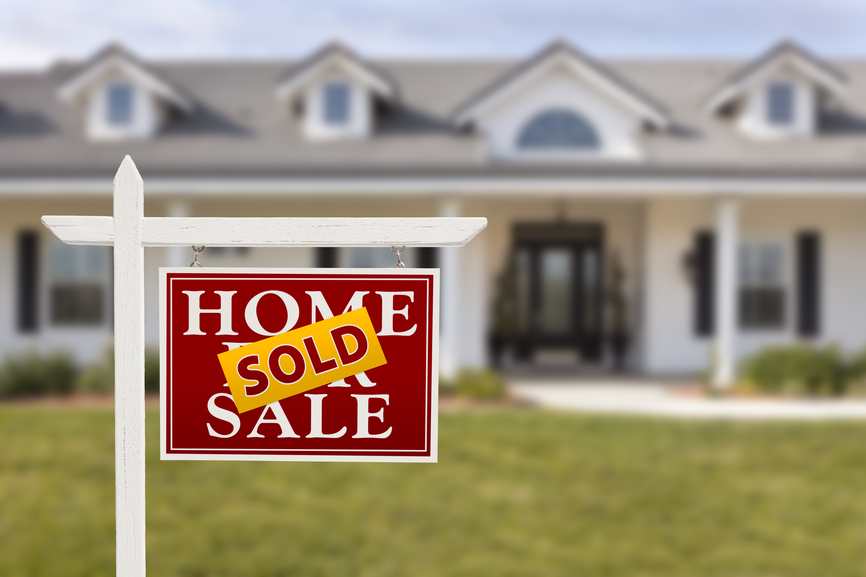 Sold Home For Sale Sign in Front of Beautiful New House.